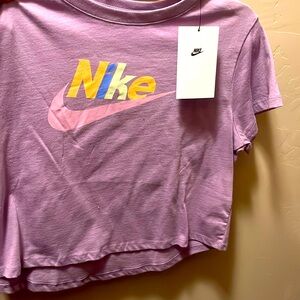 This is a brand new Nike purple shirt that says Nike in colors on the front